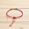 Pulsera artesanal roja: Árbol y la vida y chaquira multicolor